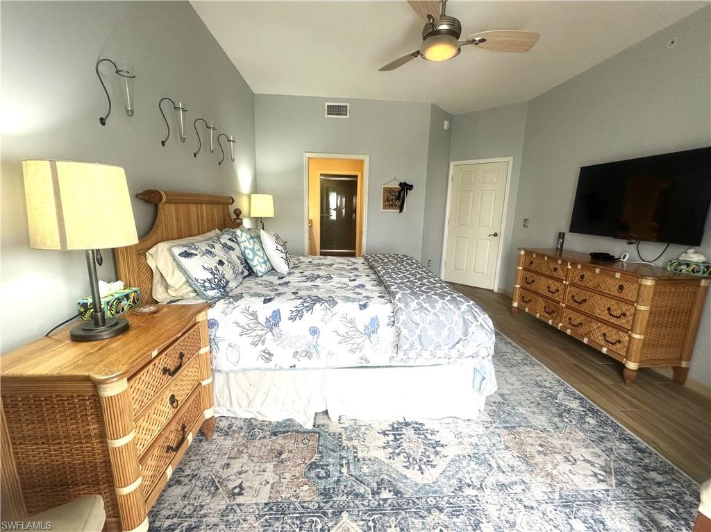 470 Launch Circle, Unit V503 Naples, FL 34108 - Photo 8 of 30 a bedroom with a bed and a flat screen tv