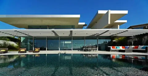 a front view of a house with a garden