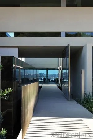 a living room with furniture a rug and a floor to ceiling window