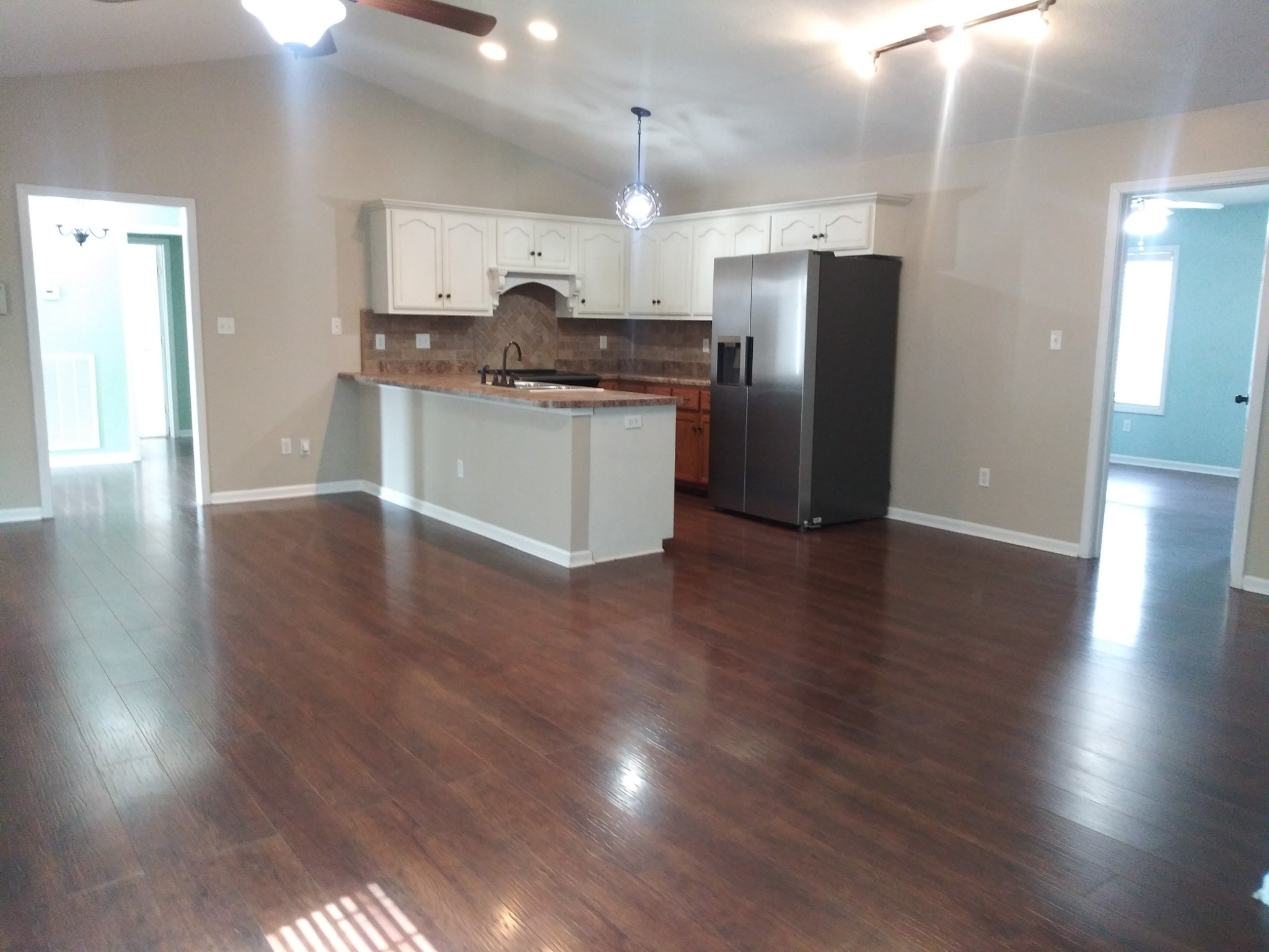 5330 Long Branch Road Tennessee Ridge, TN 37178 - Photo 27 of 57 a kitchen with stainless steel appliances granite countertop a refrigerator a sink a stove and oven with wooden floors