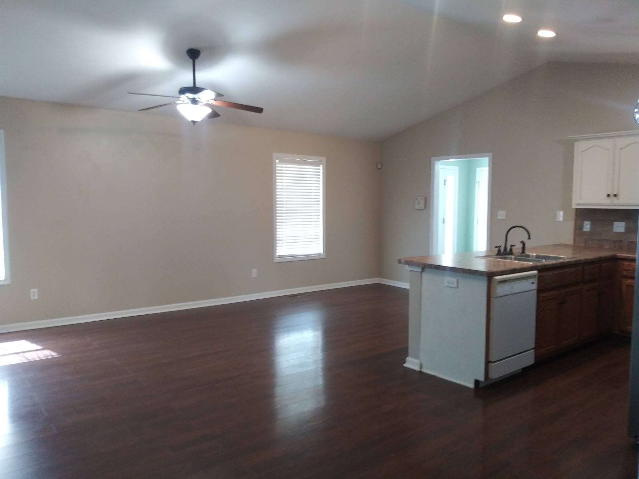5330 Long Branch Road Tennessee Ridge, TN 37178 - Photo 30 of 57 a kitchen with kitchen island granite countertop a sink cabinets and wooden floor
