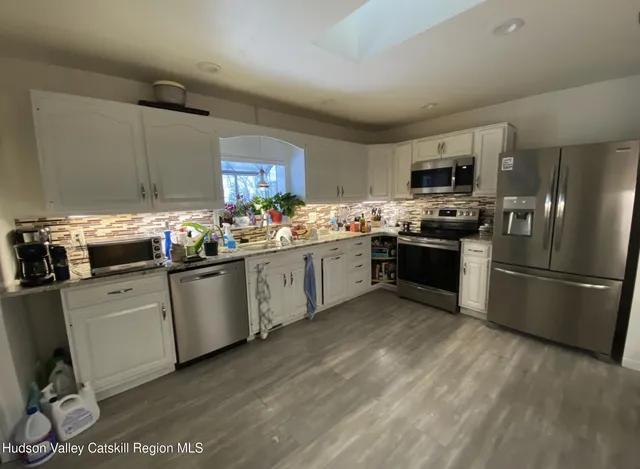 a kitchen with a sink stainless steel appliances and cabinets