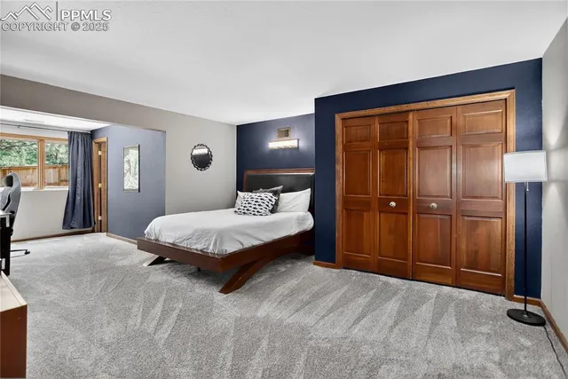 a spacious bedroom with a bed and a dresser