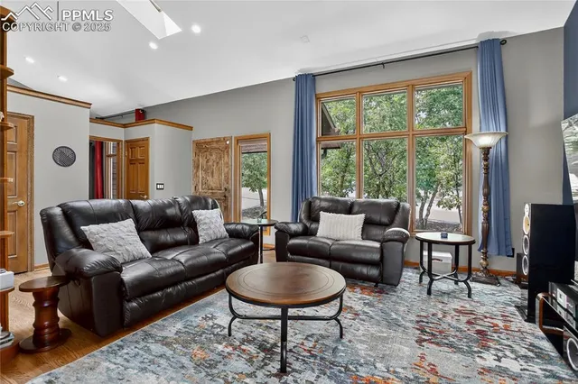 a living room with fireplace furniture and a flat screen tv
