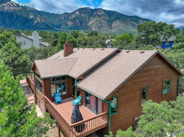 an aerial view of a house with balcony and trees