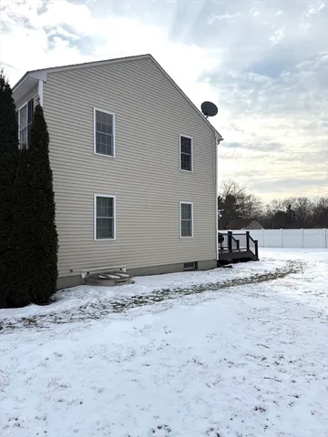 a view of a house with snow on the road