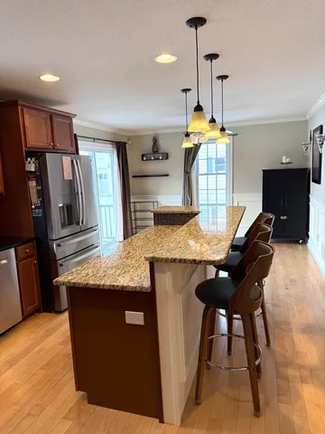 a kitchen with a table chairs refrigerator and sink
