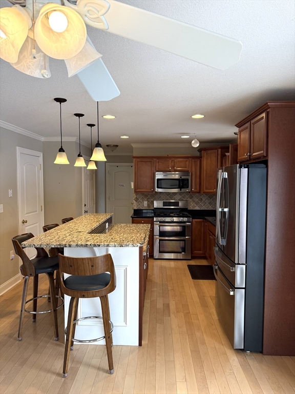 134 Granger Street Springfield, MA 01119 - Photo 4 of 15 a kitchen with a table chairs refrigerator and microwave