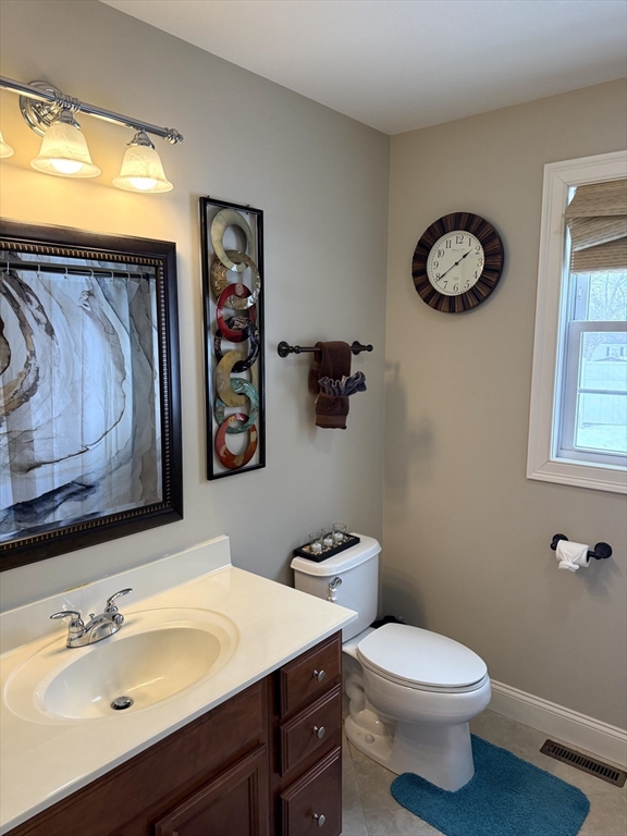 134 Granger Street Springfield, MA 01119 - Photo 7 of 15 a bathroom with a toilet sink and mirror