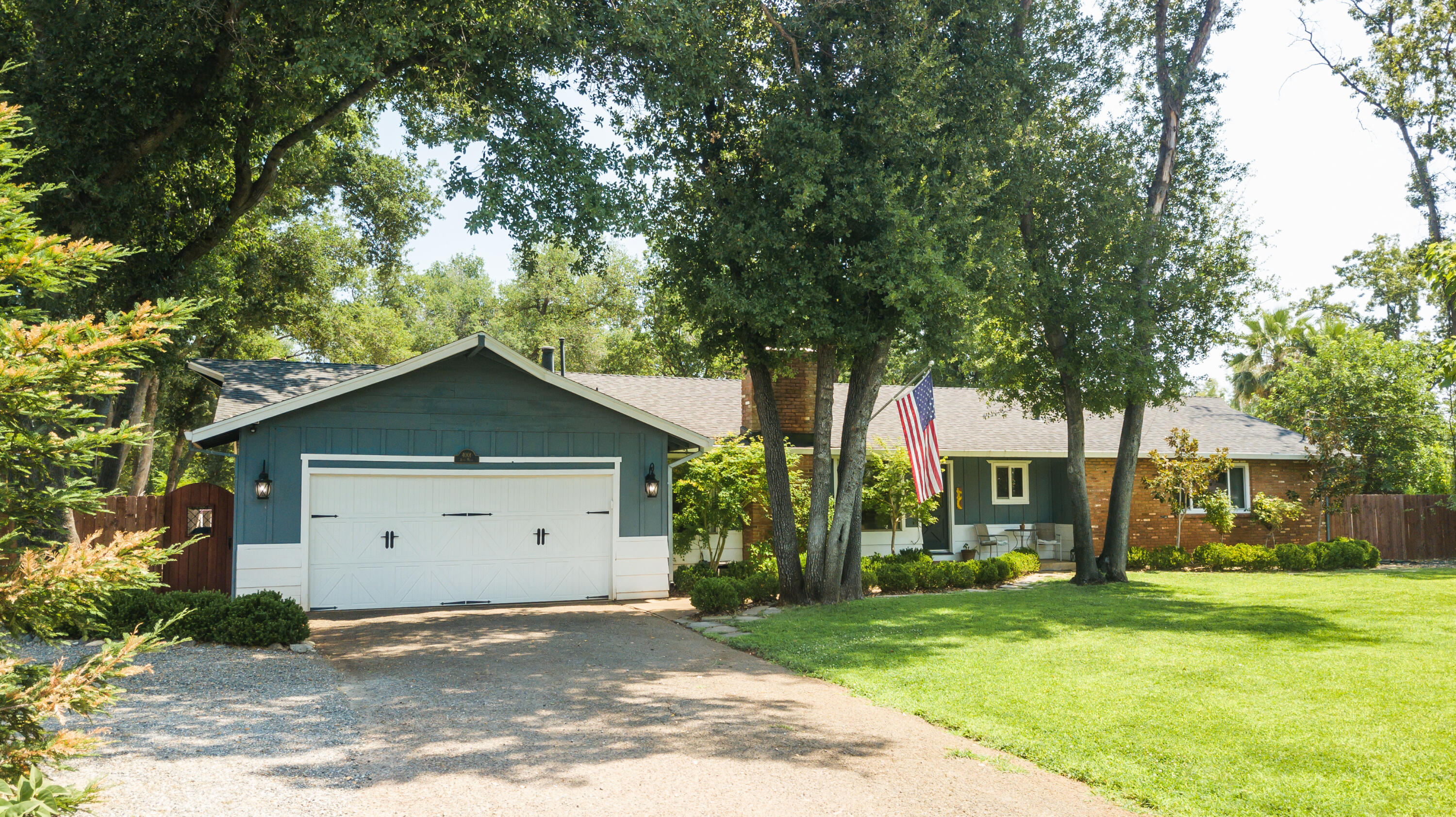 4001 Alta Mesa Drive Redding, CA 96002 - Photo 2 of 42 a view of a house with a yard and garage