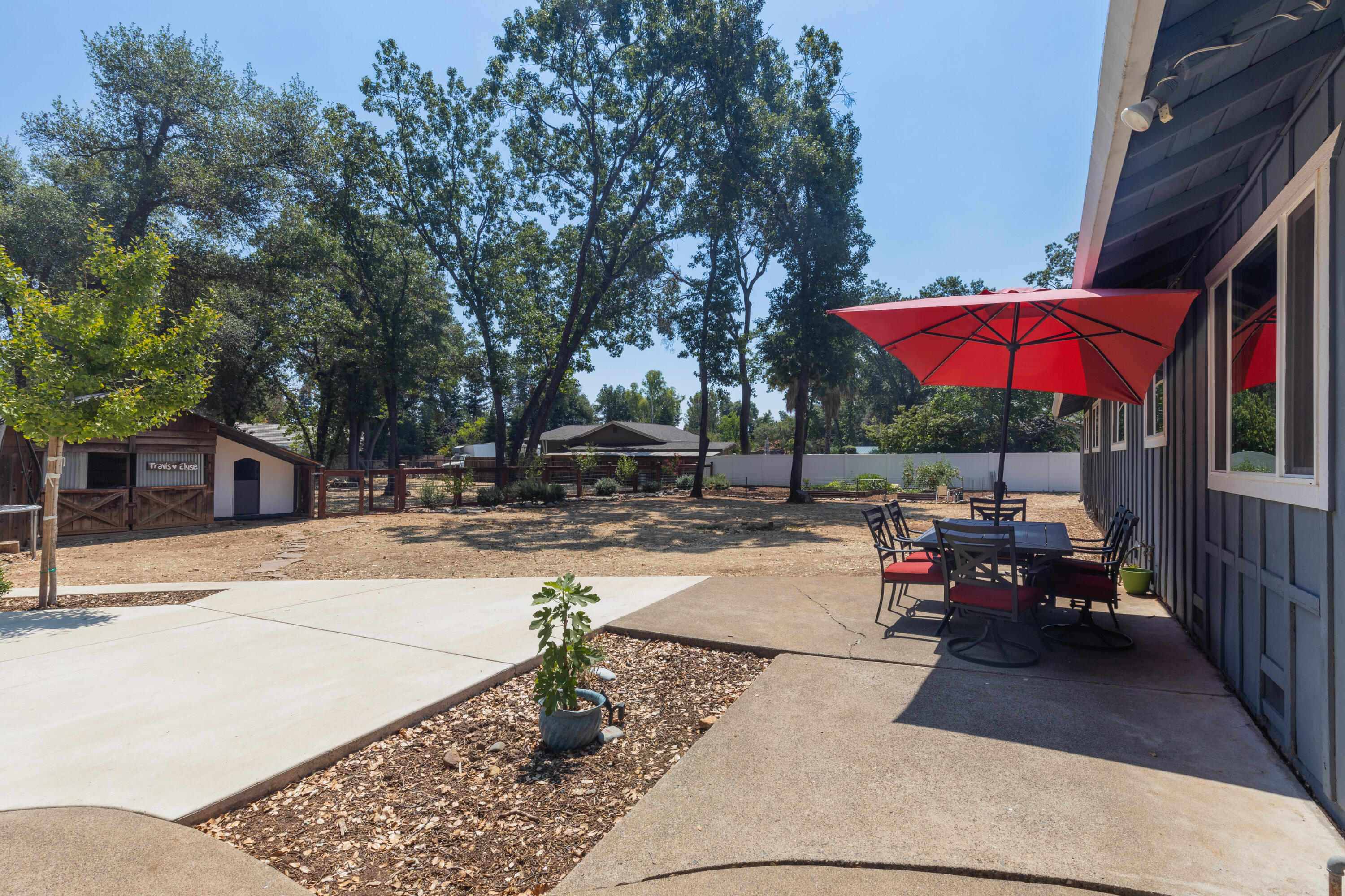 4001 Alta Mesa Drive Redding, CA 96002 - Photo 28 of 42 a view of a patio with a table and chairs under an umbrella
