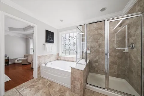 a bathroom with a bathtub and a shower