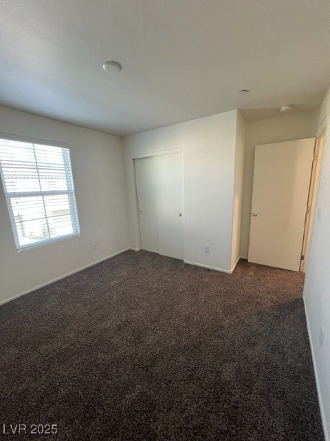 4561 Woolcomber Street Las Vegas, NV 89115 - Photo 8 of 19 Unfurnished bedroom with dark colored carpet and a closet