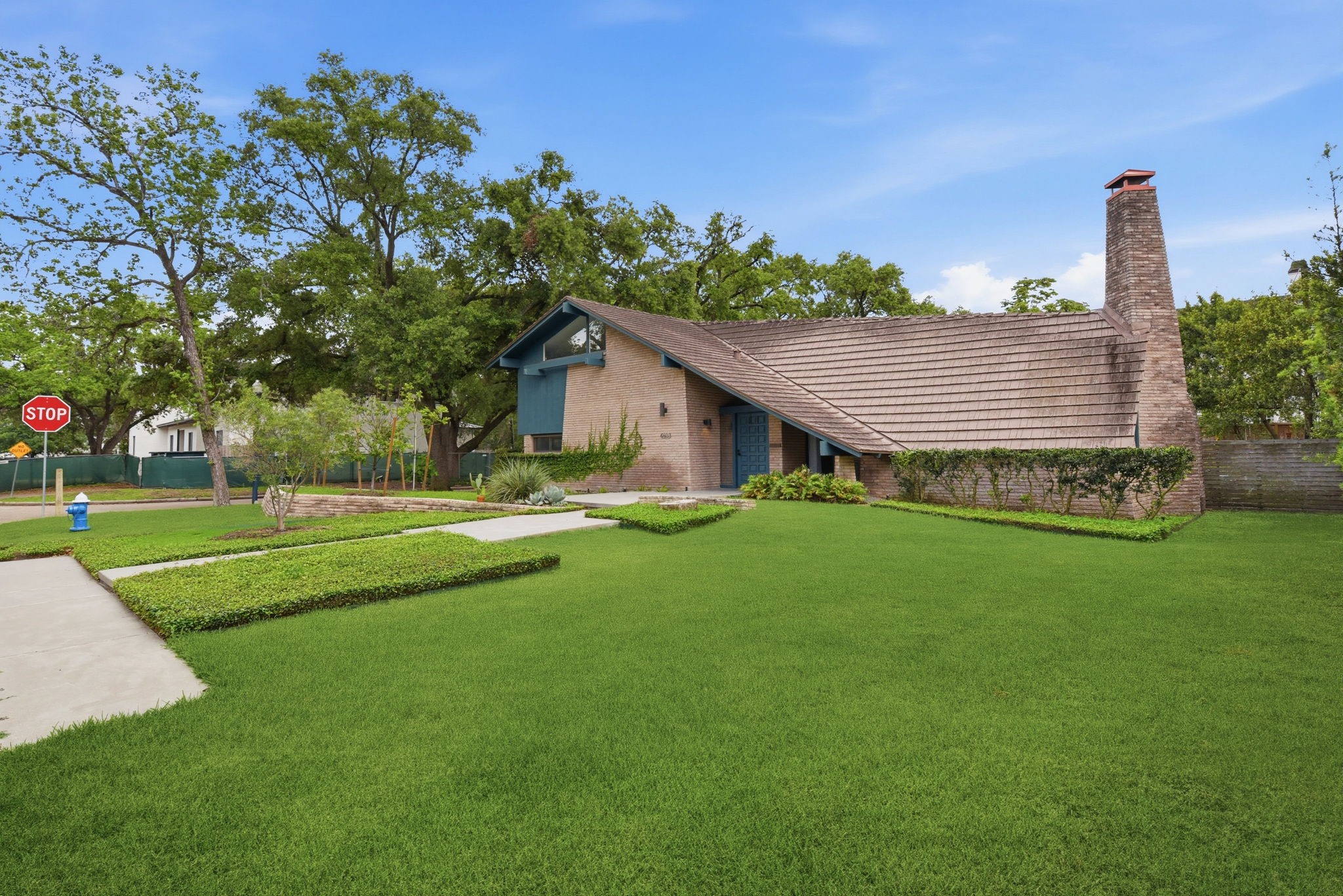 4603 Ivanhoe Street Houston, TX 77027 - Photo 3 of 50 a view of a house with a big yard and large trees