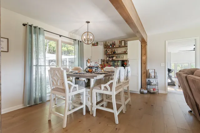 a view of a dining room with furniture wooden floor and chandelier