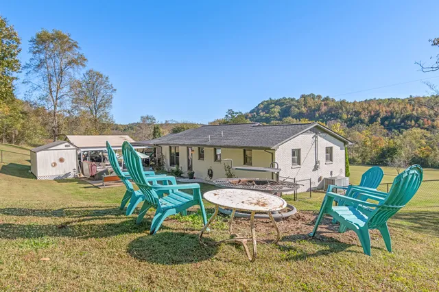 a kitchen with stainless steel appliances granite countertop a refrigerator a sink dishwasher a stove and a refrigerator with wooden floor