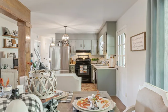 a kitchen with stainless steel appliances granite countertop a sink stove and cabinets