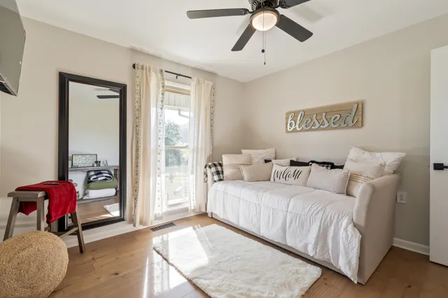 a bathroom with a granite countertop sink mirror vanity and a toilet