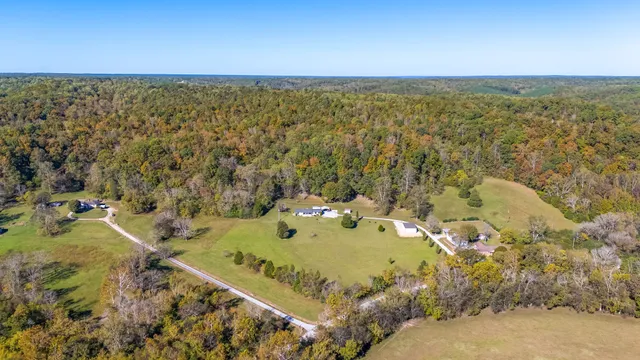 a large bed sitting in a bedroom next to a window