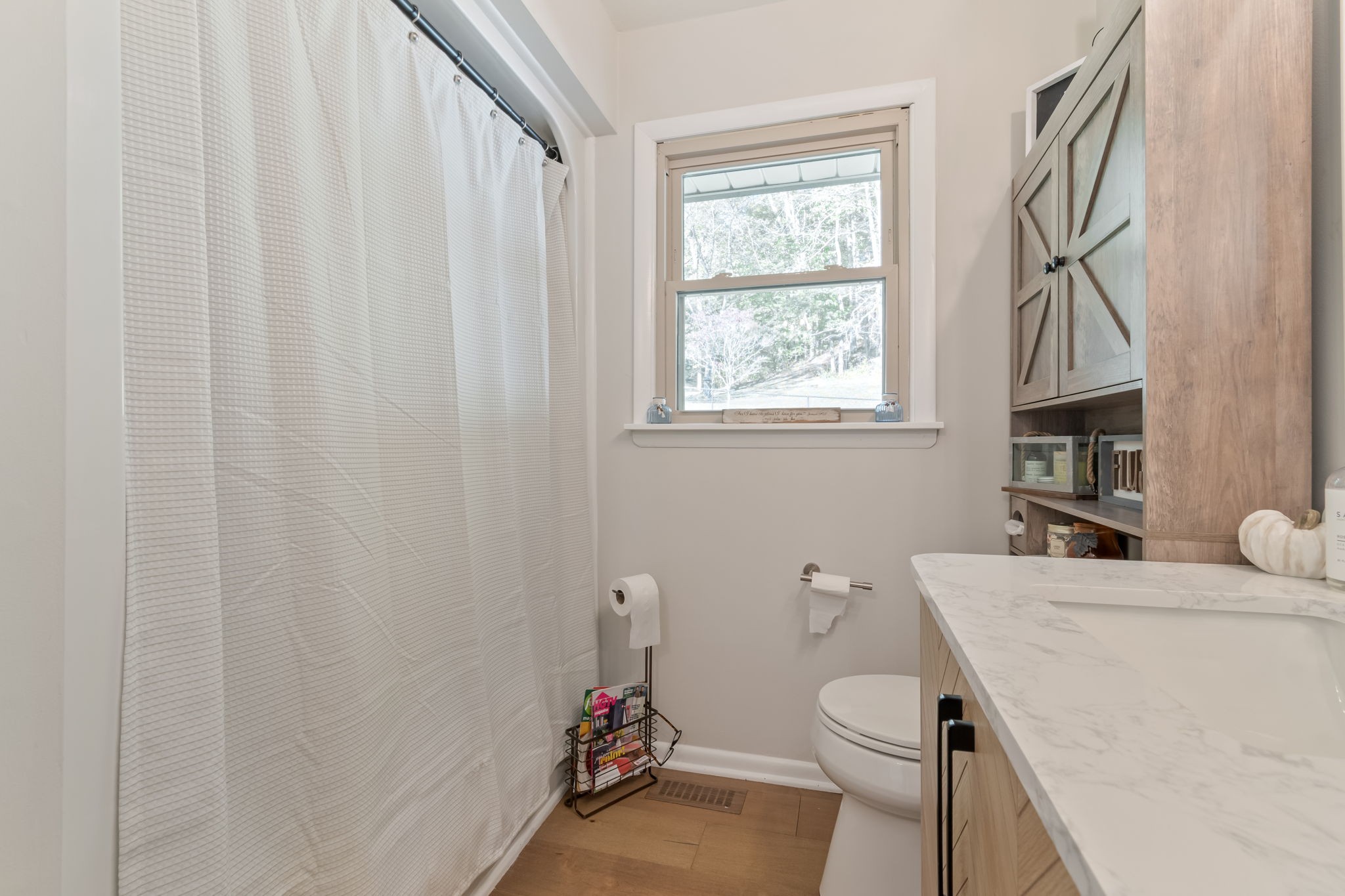 260 West Fork Road Mount Pleasant, TN 38474 - Photo 31 of 54 a bathroom with a sink a toilet and a window