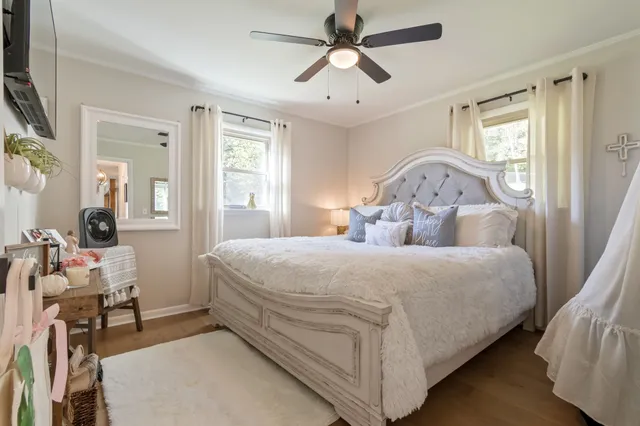 a bedroom with a bed and dresser with mirror