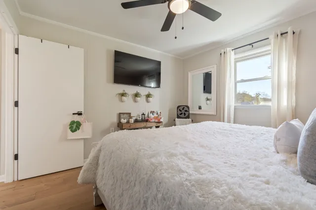 a bedroom with a bed and a chandelier