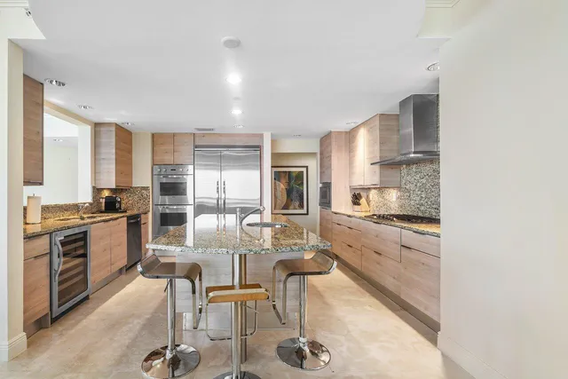 a kitchen with granite countertop a sink and a stove