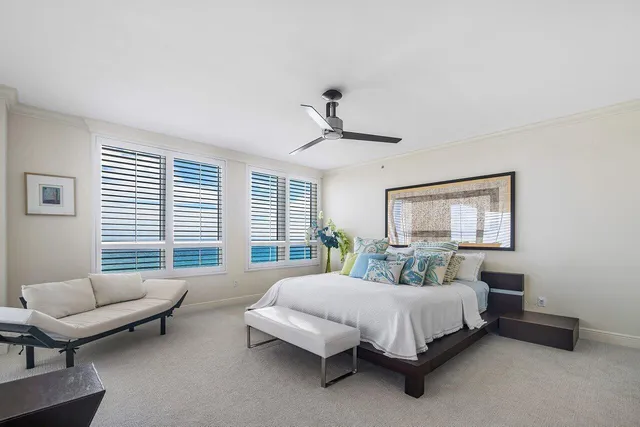 a bedroom with furniture and a large window