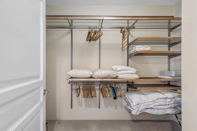 a large bathroom with a glass shower door and a sink