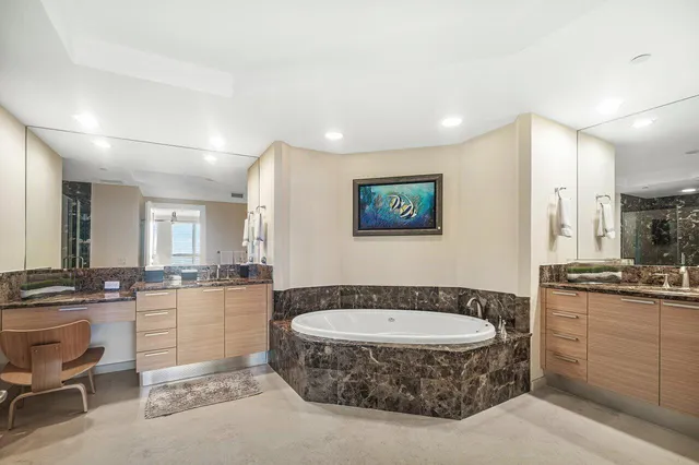 a bathroom with a double vanity sink toilet and shower