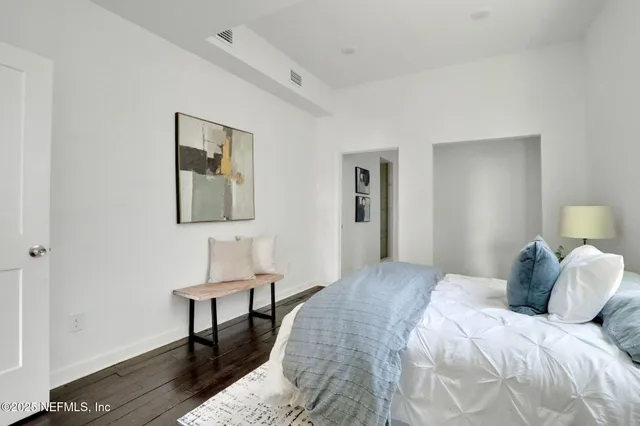 a bedroom with a bed and a table