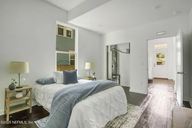 a bedroom with a bed and a night stand