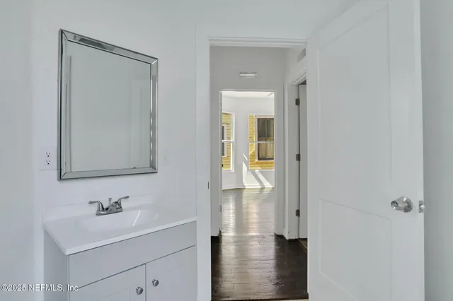 a bathroom with a sink a mirror and a shower