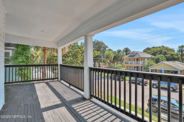 a view of a balcony with wooden floor