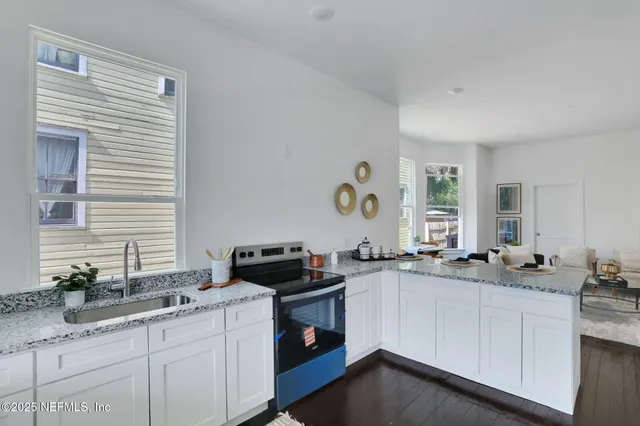 a kitchen with a sink stove and cabinets