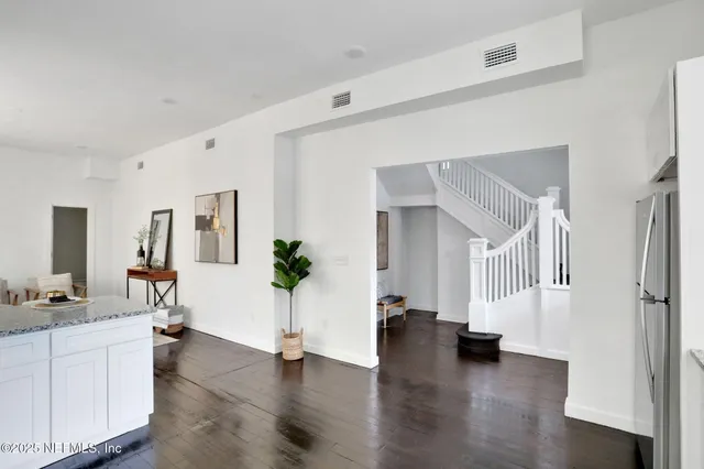 a view of an entryway with wooden floor and windows