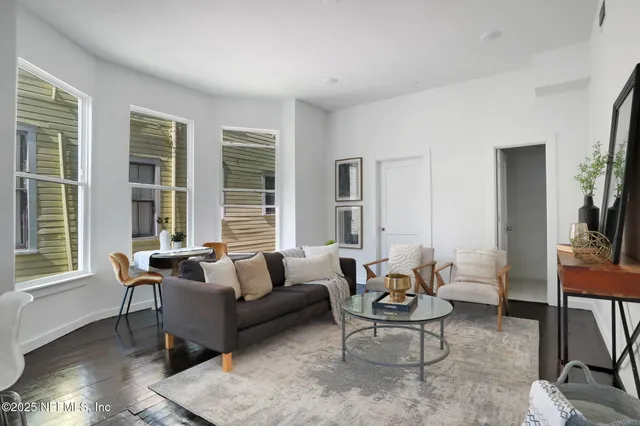 a living room with furniture and a large window