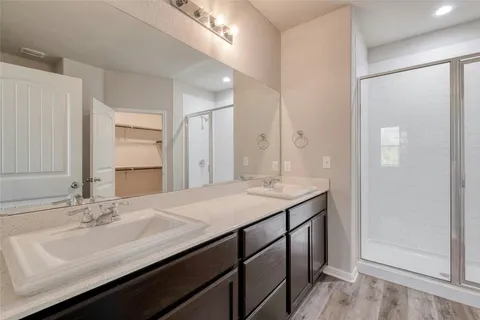 a bathroom with a double vanity sink and mirror
