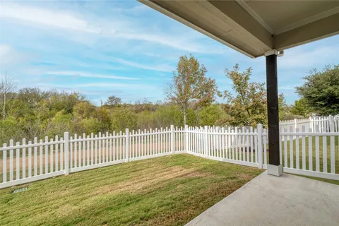 a view of a house with wooden fence