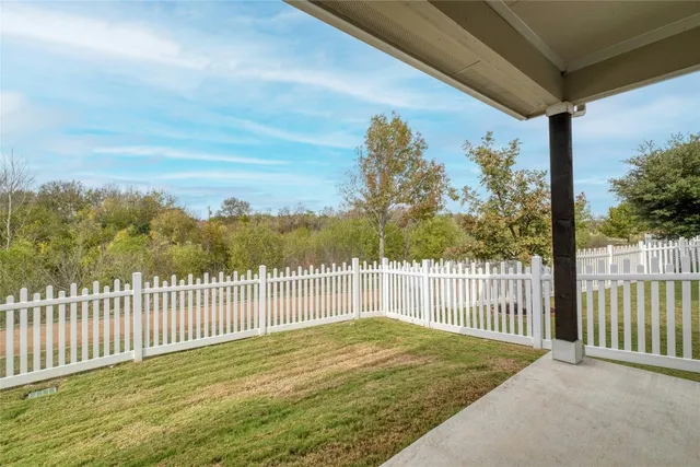 a view of a house with wooden fence