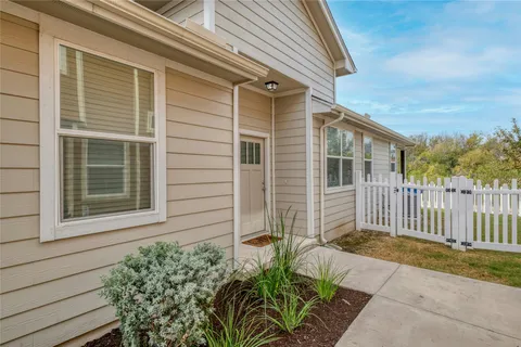 a view of house with wooden fence