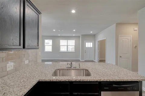 a kitchen with granite countertop a sink and a granite counter top