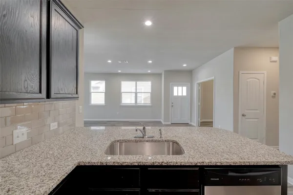 a kitchen with granite countertop a sink and a granite counter top