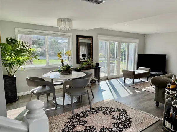 a view of a livingroom with furniture and a floor to ceiling window