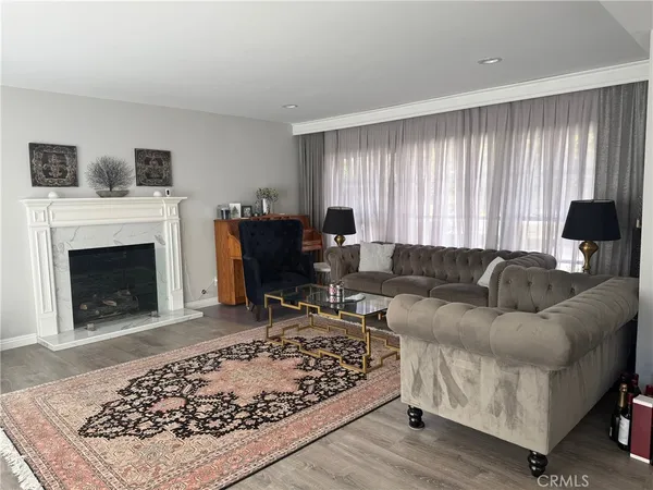 a living room with furniture and a fireplace