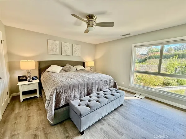 a bedroom with a bed and a large window