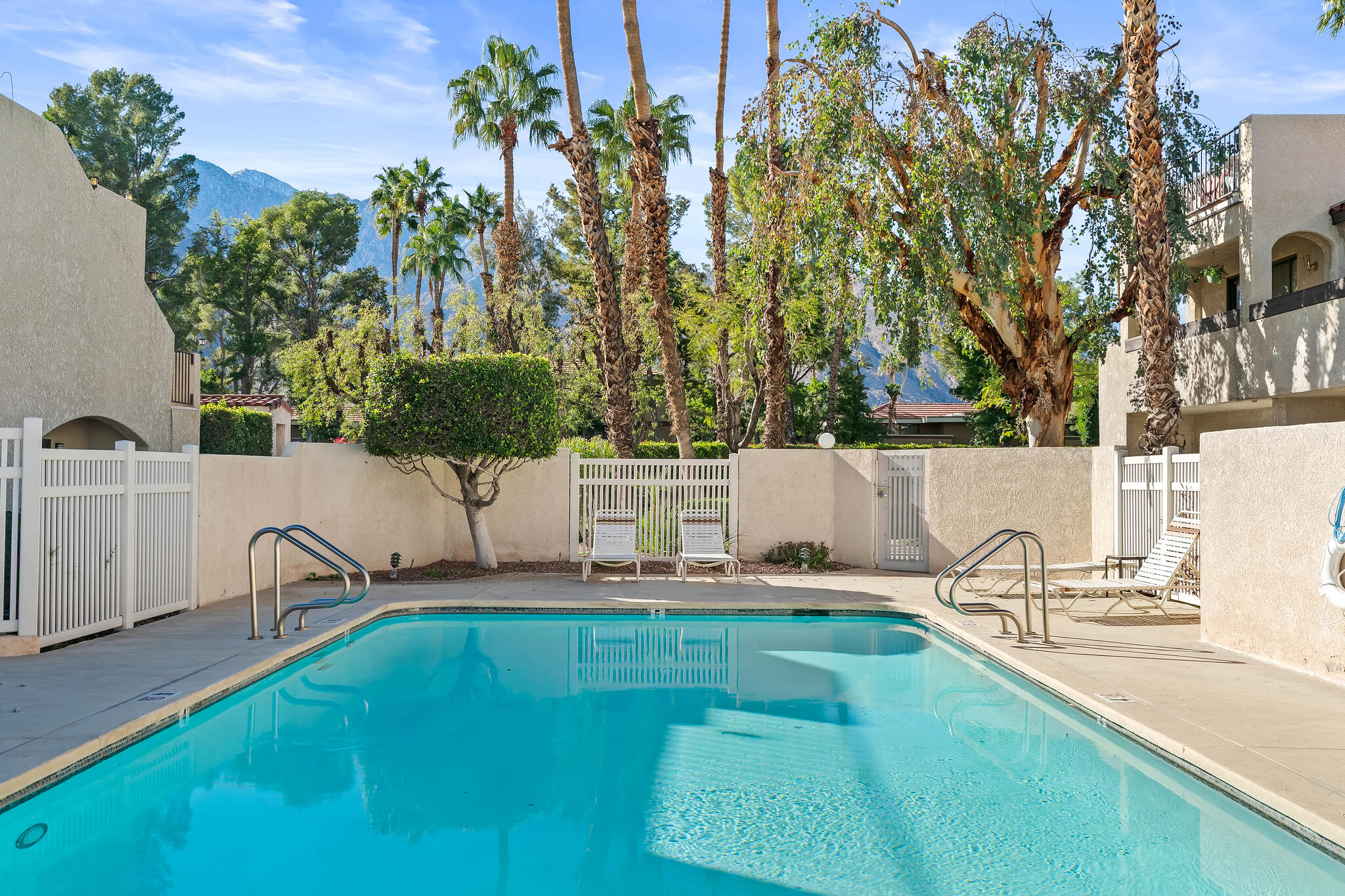 200 East Racquet Club Road, Unit 54 Palm Springs, CA 92262 - Photo 25 of 29 a view of a swimming pool with a patio and a yard