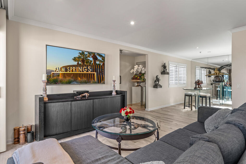 200 East Racquet Club Road, Unit 54 Palm Springs, CA 92262 - Photo 7 of 29 a living room with furniture and a wooden floor