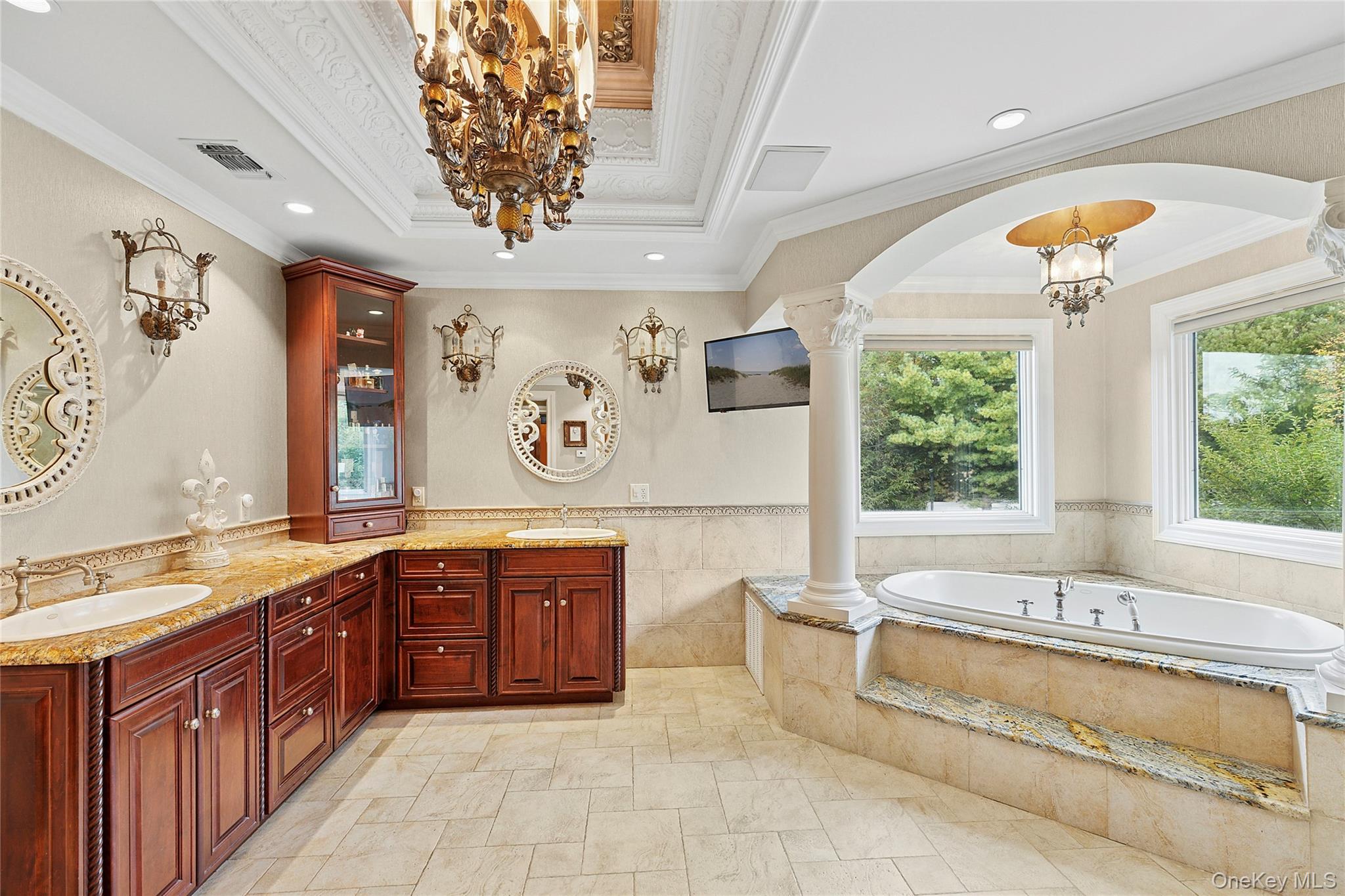 5 Schoolhouse Court Oyster Bay, NY 11771 - Photo 14 of 33 a spacious bathroom with a tub sink and mirror