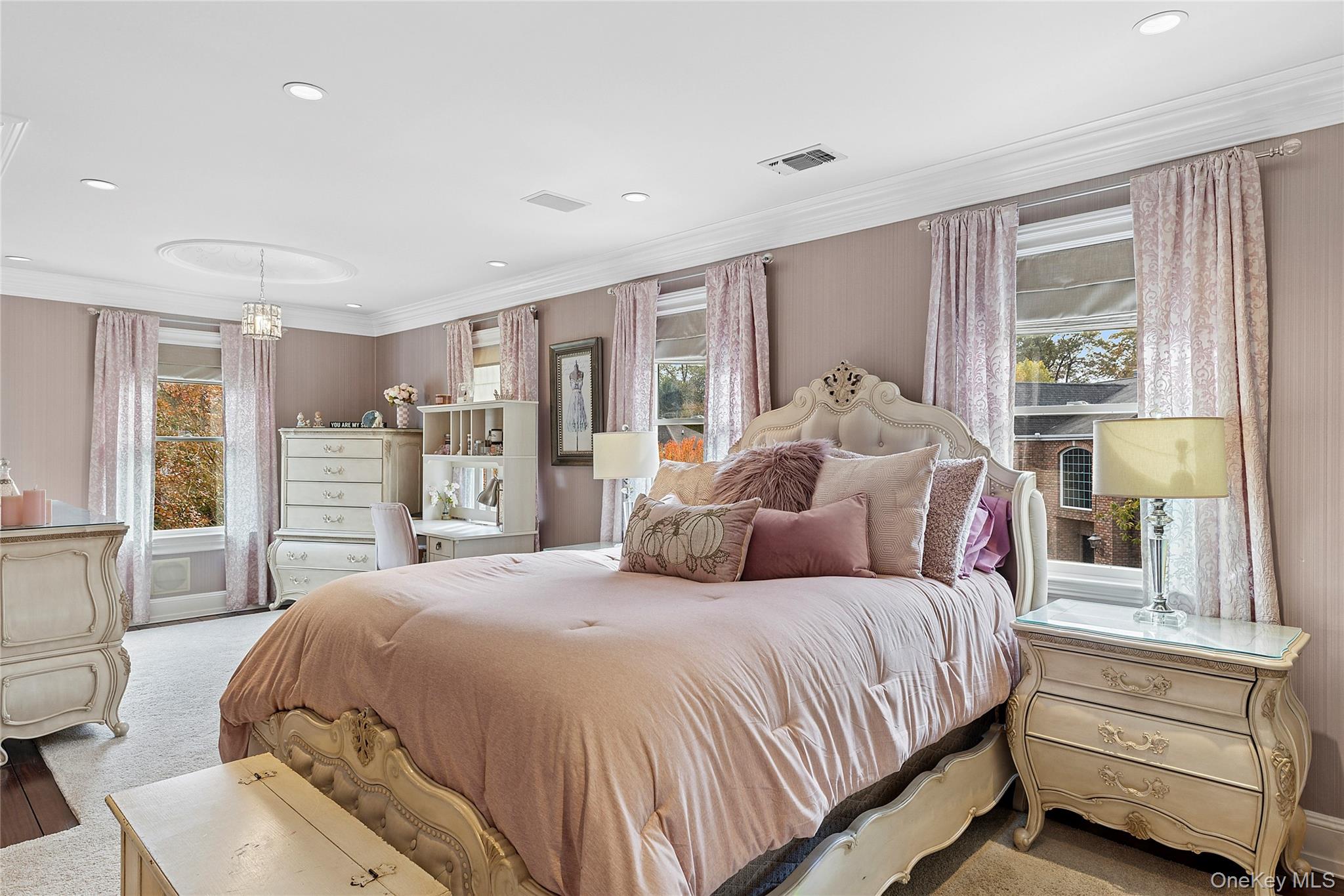 5 Schoolhouse Court Oyster Bay, NY 11771 - Photo 16 of 33 a spacious bedroom with a bed a table and large window